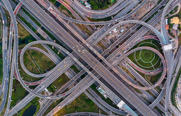 A highway interchange inside a large city lit up at night.